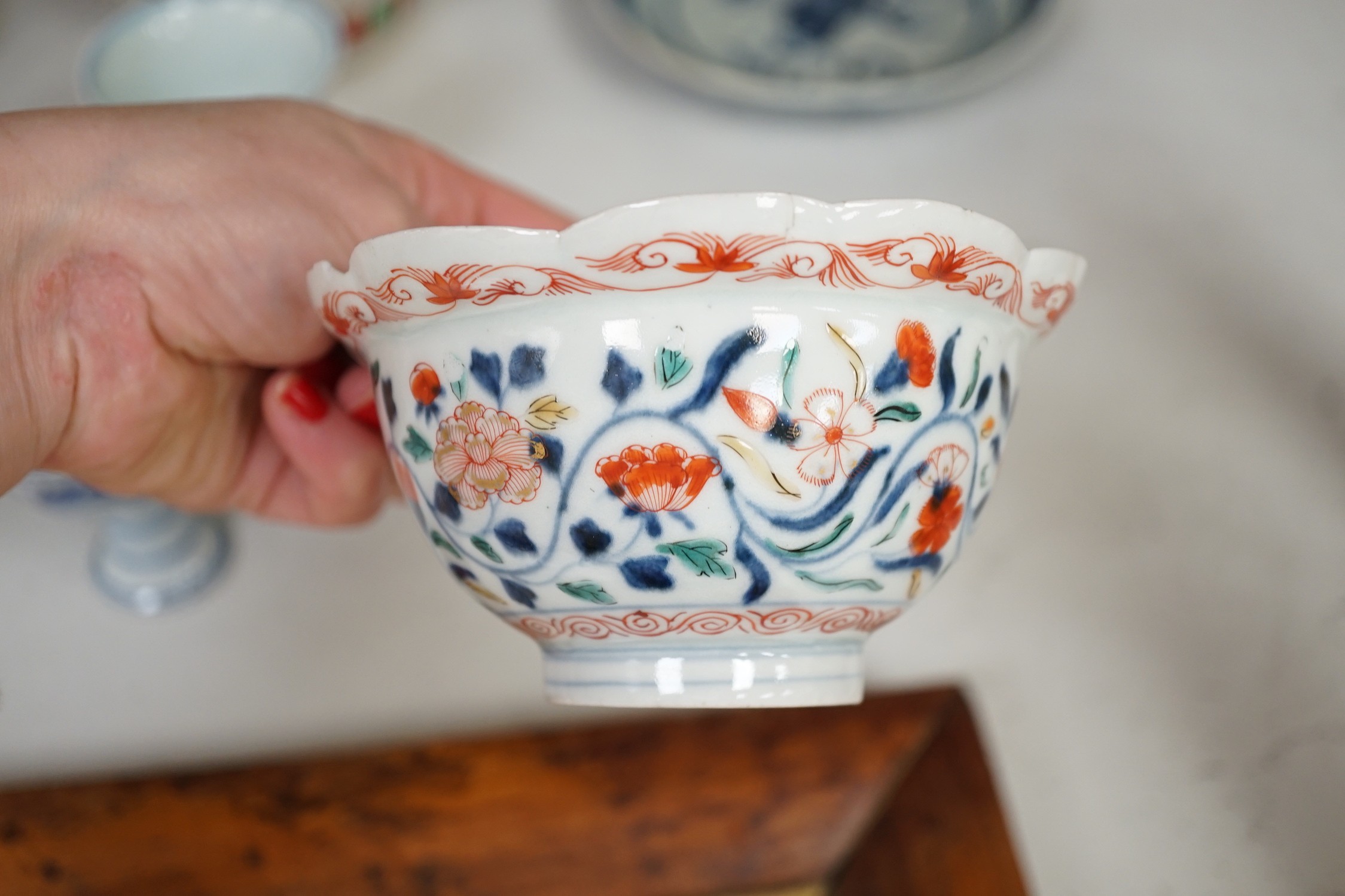 A Chinese wucai vase, two Imari bowls, a pair of Chinese blue and white dragon stem cups, Xuande marks, a Chinese blue and white dish, depicting a scholar on horseback, Xuande mark, a small green Chinese bowl, painted wi